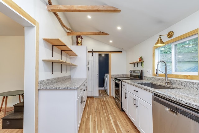 53 Broad Cove Dr, Concord, NH 03303 - kitchen featuring open shelves, stainless steel appliances, a barn door, white cabinetry, and light wood-style flooring
