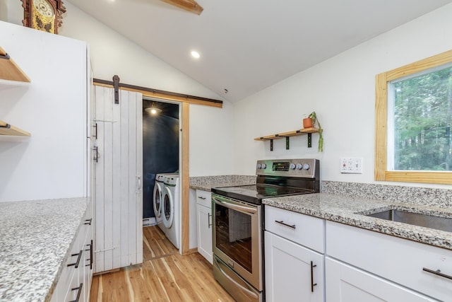 53 Broad Cove Dr, Concord, NH 03303 - kitchen with electric range, open shelves, washing machine and dryer, light wood-style flooring, and lofted ceiling