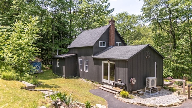 53 Broad Cove Dr, Concord, NH 03303 - view of side of home with a shingled roof, a chimney, entry steps, an outbuilding, and a yard