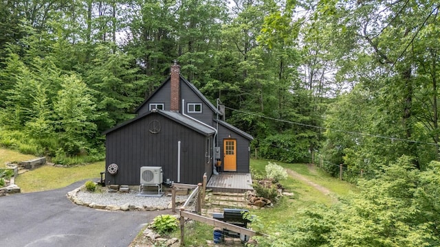 53 Broad Cove Dr, Concord, NH 03303 - view of side of home featuring a deck, a chimney, and a wooded view