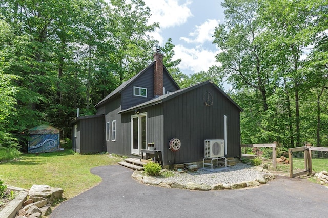 53 Broad Cove Dr, Concord, NH 03303 - view of home's exterior with a chimney and a yard