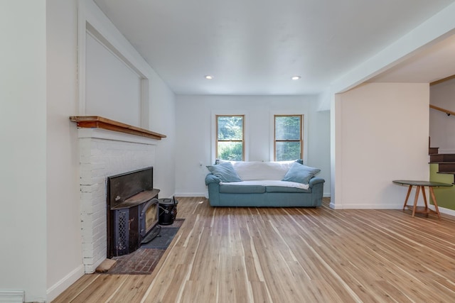 53 Broad Cove Dr, Concord, NH 03303 - living room featuring hardwood / wood-style flooring, stairway, recessed lighting, and a brick fireplace