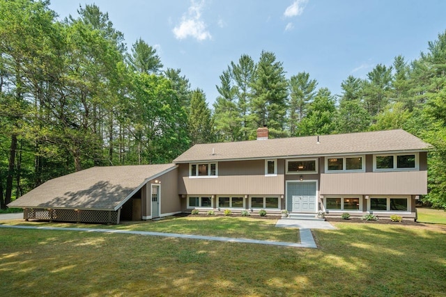 10 Lawrence Ln, Hollis, NH 03049 - raised ranch featuring a front lawn, a chimney, and view of scattered trees