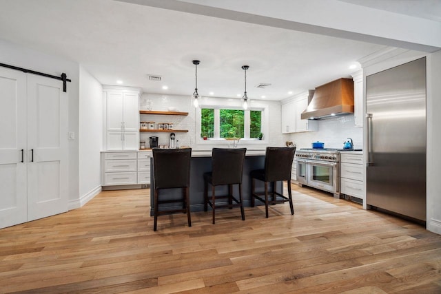 10 Lawrence Ln, Hollis, NH 03049 - kitchen with wall chimney range hood, high end appliances, decorative backsplash, light wood-type flooring, and white cabinets