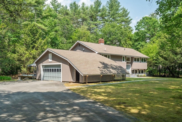 10 Lawrence Ln, Hollis, NH 03049 - view of front of home featuring driveway, an attached garage, roof with shingles, a front lawn, and a chimney