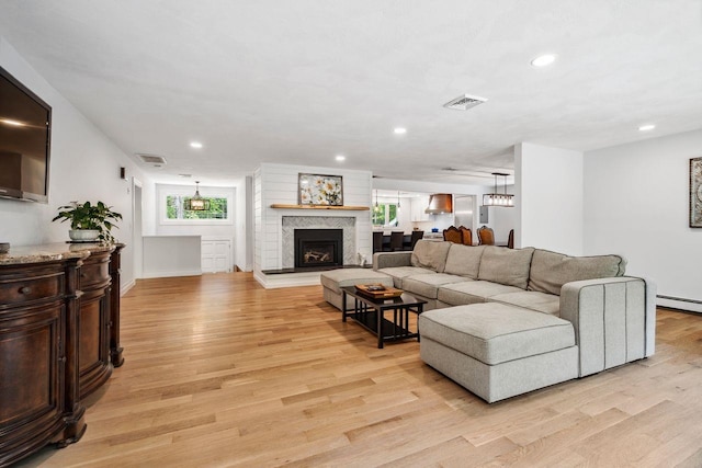 10 Lawrence Ln, Hollis, NH 03049 - living area with light wood-style flooring, a fireplace with raised hearth, and recessed lighting