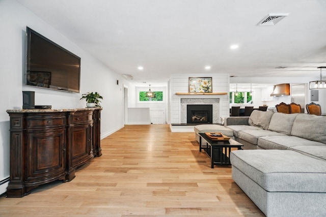 10 Lawrence Ln, Hollis, NH 03049 - living room featuring light wood-type flooring, recessed lighting, and a fireplace with raised hearth