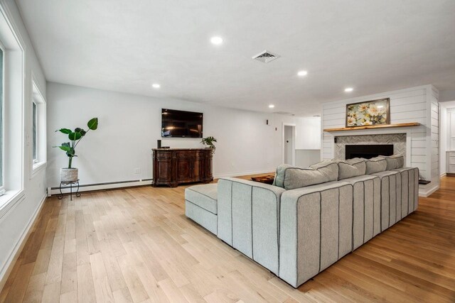 10 Lawrence Ln, Hollis, NH 03049 - living area featuring a baseboard heating unit, a fireplace, recessed lighting, and light wood finished floors