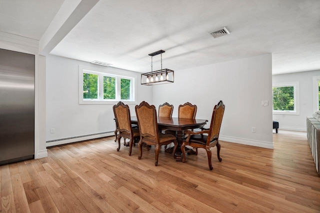 10 Lawrence Ln, Hollis, NH 03049 - dining room featuring baseboard heating, light wood-style flooring, and healthy amount of natural light