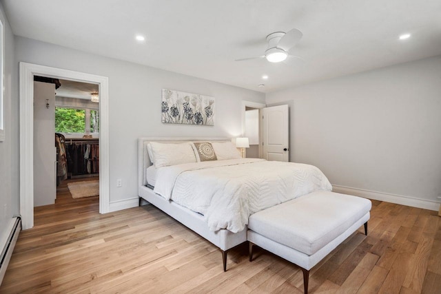 10 Lawrence Ln, Hollis, NH 03049 - bedroom with light wood-style flooring, a baseboard radiator, ceiling fan, recessed lighting, and a walk in closet