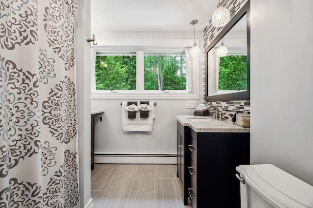 10 Lawrence Ln, Hollis, NH 03049 - full bathroom featuring a baseboard radiator, vanity, and decorative backsplash