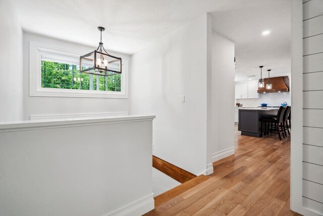 10 Lawrence Ln, Hollis, NH 03049 - hall with a chandelier, light wood-type flooring, an upstairs landing, and recessed lighting