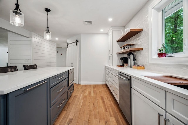 10 Lawrence Ln, Hollis, NH 03049 - kitchen with dishwasher, a barn door, open shelves, white cabinetry, and light wood-style flooring