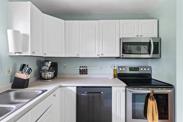 78 Lyman Park Rd Unit 1, Hinesburg, VT 05461 - kitchen with stainless steel appliances, white cabinets, and light countertops