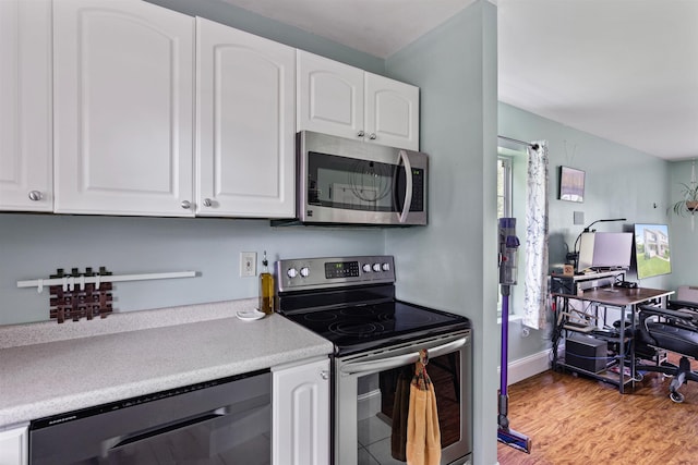 78 Lyman Park Rd Unit 1, Hinesburg, VT 05461 - kitchen featuring appliances with stainless steel finishes, white cabinets, light countertops, light wood-style flooring, and an office area