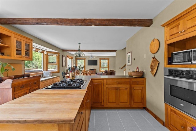 429 Polhemus Rd, Cambridge, VT 05464 - kitchen with oven, gas cooktop, black microwave, wooden counters, and beamed ceiling