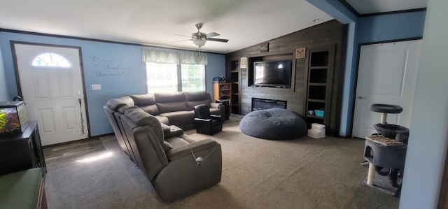 5 Mildred Ave, Raymond, NH 03077 - living room featuring ornamental molding, vaulted ceiling, ceiling fan, dark carpet, and a large fireplace