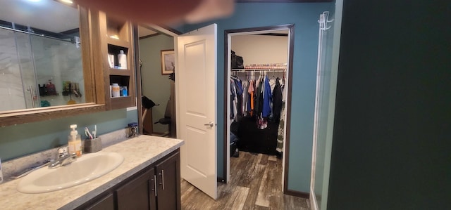 5 Mildred Ave, Raymond, NH 03077 - full bath featuring wood finished floors, vanity, a walk in closet, and a shower with shower door