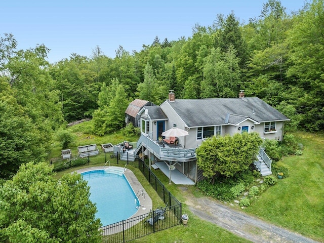 89 Carlson Rd, Worcester, VT 05682 - rear view of house with a chimney, a wooden deck, a wooded view, stairway, and dirt driveway