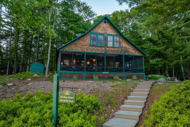 310 Bear Is, Meredith, NH 03253 - view of front of property featuring a sunroom, stairway, and ceiling fan