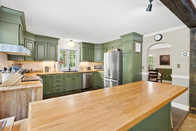 38 Piscataqua Rd, Dover, NH 03820 - kitchen with green cabinets, appliances with stainless steel finishes, under cabinet range hood, dark wood-type flooring, and ornamental molding