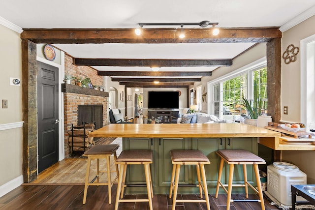 38 Piscataqua Rd, Dover, NH 03820 - kitchen featuring dark wood-type flooring, beam ceiling, butcher block counters, a fireplace, and a breakfast bar