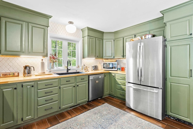 38 Piscataqua Rd, Dover, NH 03820 - kitchen with appliances with stainless steel finishes, light countertops, green cabinetry, and dark wood finished floors