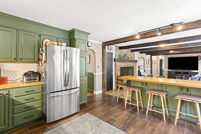 38 Piscataqua Rd, Dover, NH 03820 - kitchen featuring freestanding refrigerator, wooden counters, a fireplace, dark wood-type flooring, and arched walkways