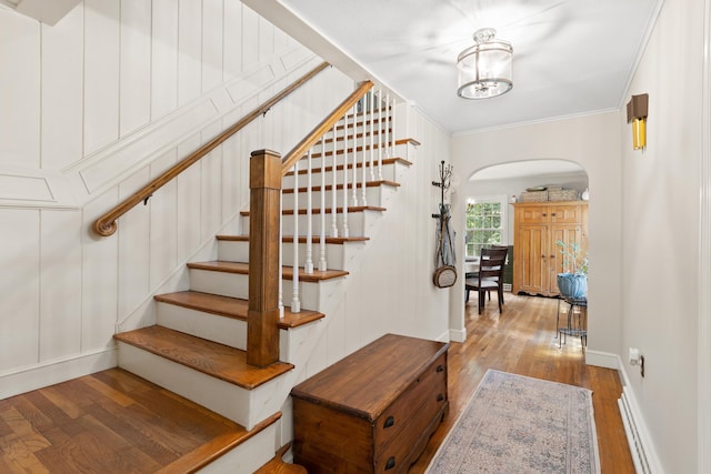 38 Piscataqua Rd, Dover, NH 03820 - staircase with arched walkways, hardwood / wood-style floors, crown molding, and a chandelier
