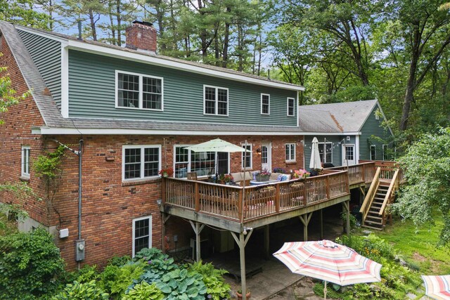38 Piscataqua Rd, Dover, NH 03820 - back of house with brick siding, a wooden deck, a chimney, and roof with shingles