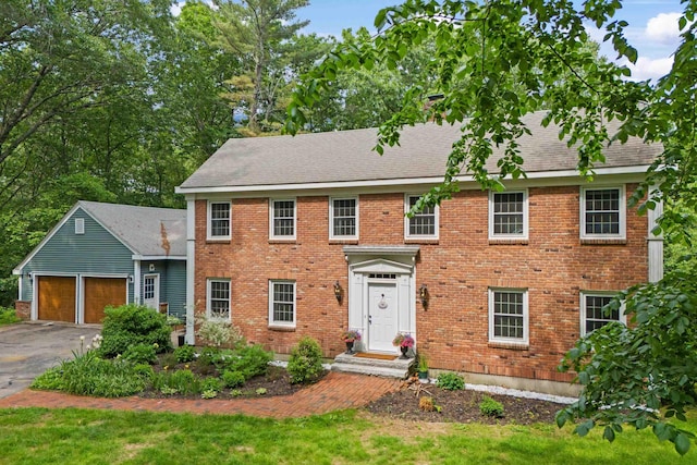 38 Piscataqua Rd, Dover, NH 03820 - view of front of home with an attached garage, asphalt driveway, brick siding, and a front lawn