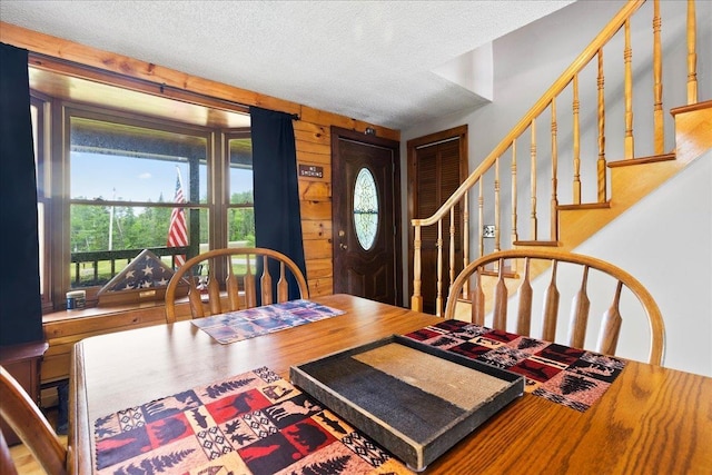 110 W Milan Rd, Milan, NH 03588 - dining area featuring plenty of natural light, stairs, a textured ceiling, and wood finished floors