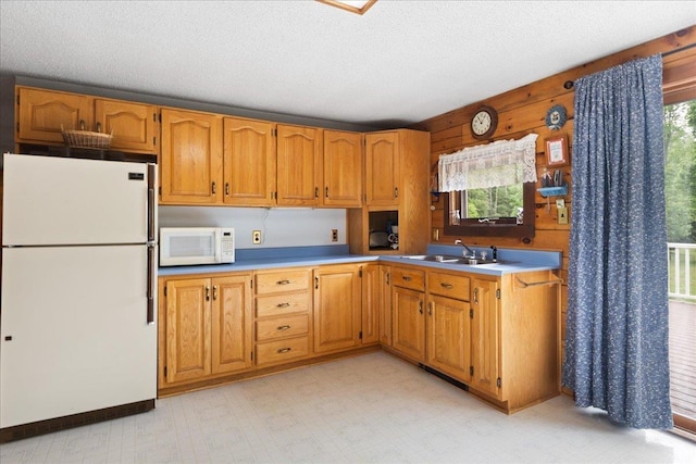 110 W Milan Rd, Milan, NH 03588 - kitchen with white appliances, plenty of natural light, wood walls, a textured ceiling, and light countertops