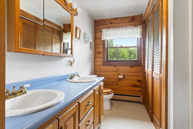 110 W Milan Rd, Milan, NH 03588 - bathroom featuring a baseboard heating unit, double vanity, and wooden walls