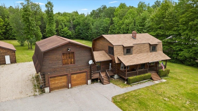 110 W Milan Rd, Milan, NH 03588 - log cabin with covered porch, a gambrel roof, roof with shingles, asphalt driveway, and a front yard
