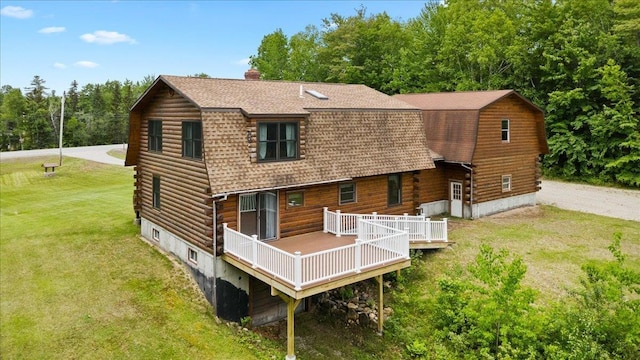 110 W Milan Rd, Milan, NH 03588 - back of house with log siding, roof with shingles, a gambrel roof, a yard, and a wooden deck