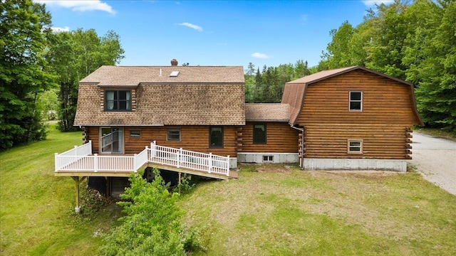 110 W Milan Rd, Milan, NH 03588 - rear view of house with log siding, a gambrel roof, roof with shingles, and a wooden deck