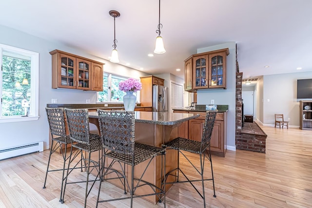 28 New Searles Rd, Nashua, NH 03062 - kitchen with stainless steel refrigerator with ice dispenser, a kitchen breakfast bar, healthy amount of natural light, and recessed lighting