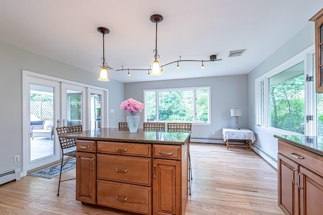 28 New Searles Rd, Nashua, NH 03062 - kitchen with a baseboard radiator, light wood-style flooring, brown cabinets, and hanging light fixtures