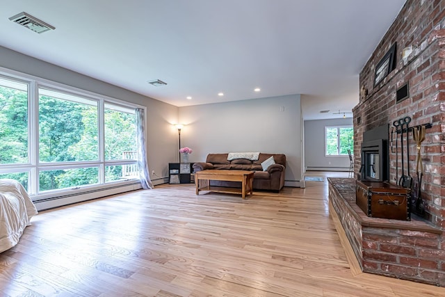 28 New Searles Rd, Nashua, NH 03062 - living room featuring light wood-type flooring, a baseboard heating unit, recessed lighting, a brick fireplace, and baseboard heating