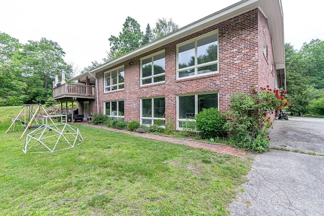 28 New Searles Rd, Nashua, NH 03062 - back of property with brick siding, a lawn, and a wooden deck
