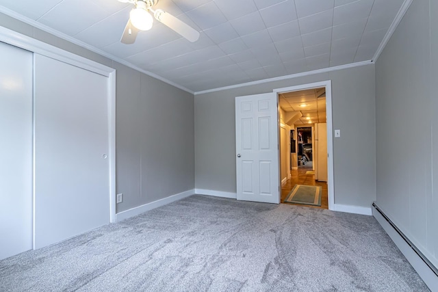 28 New Searles Rd, Nashua, NH 03062 - unfurnished bedroom featuring a baseboard radiator, carpet, ornamental molding, ceiling fan, and a closet