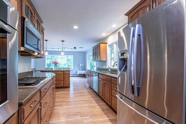 28 New Searles Rd, Nashua, NH 03062 - kitchen featuring stainless steel appliances, light wood finished floors, glass insert cabinets, hanging light fixtures, and recessed lighting