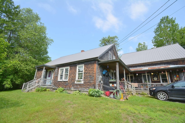151 Sunset Rock Rd, Lebanon, NH 03766 - view of front of property featuring a front yard, a porch, a metal roof, and a chimney