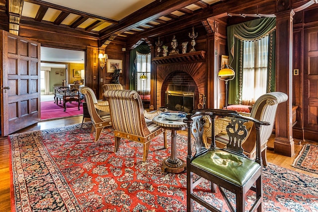 2 Croydon Brook Rd, Newport, NH 03773 - living area featuring wooden walls, a brick fireplace, crown molding, wood finished floors, and beam ceiling