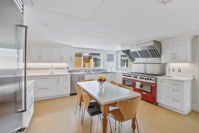 2 Croydon Brook Rd, Newport, NH 03773 - kitchen with high quality appliances, wall chimney range hood, white cabinets, light countertops, and light floors