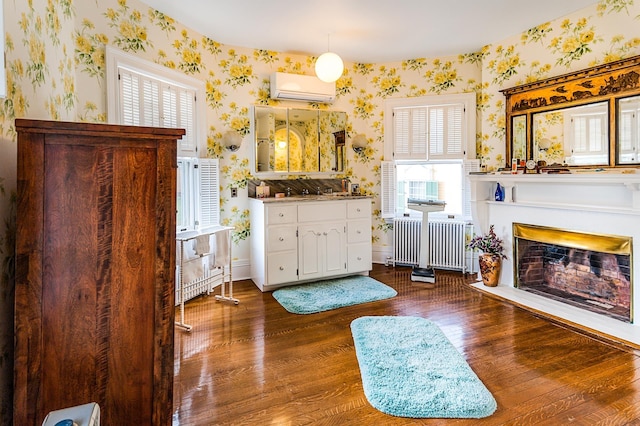 2 Croydon Brook Rd, Newport, NH 03773 - bathroom featuring wallpapered walls, radiator, a wall unit AC, wood finished floors, and vanity