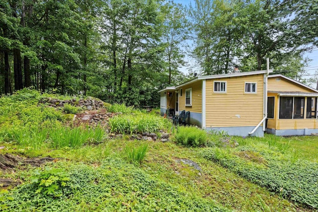 15 Milford St, Amherst, NH 03031 - view of side of home featuring a sunroom and a chimney