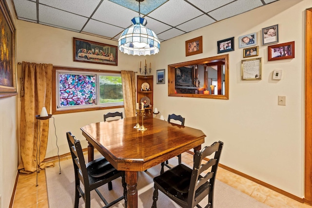 15 Milford St, Amherst, NH 03031 - dining space featuring light tile patterned flooring and a paneled ceiling