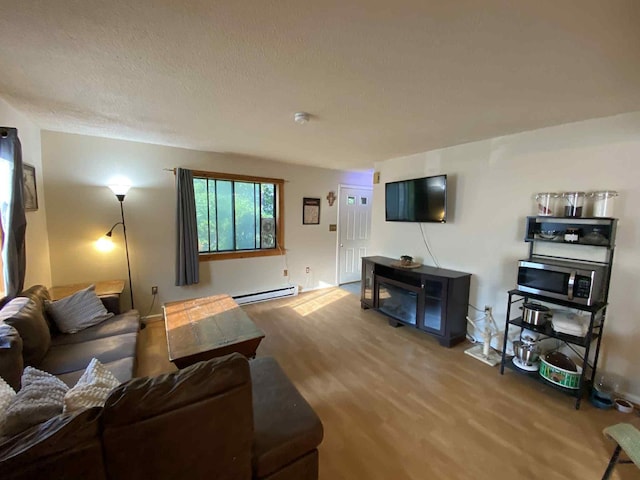 5 Swiftwater Dr Unit 8, Allenstown, NH 03275 - living area featuring a baseboard heating unit and wood finished floors